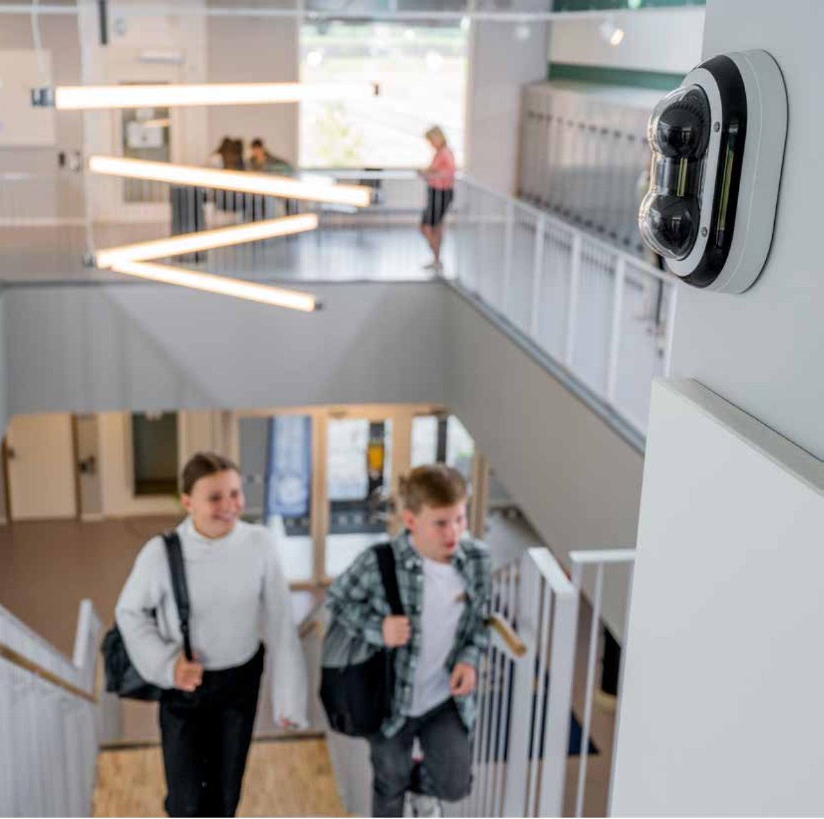 Axis network camera monitoring a school hallway as students walk by